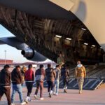 Repeating abstract geometric pattern in deep blue and violet tones forming a modern tiled background