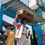 Contemporary glass-paneled office building reflecting blue sky and clouds