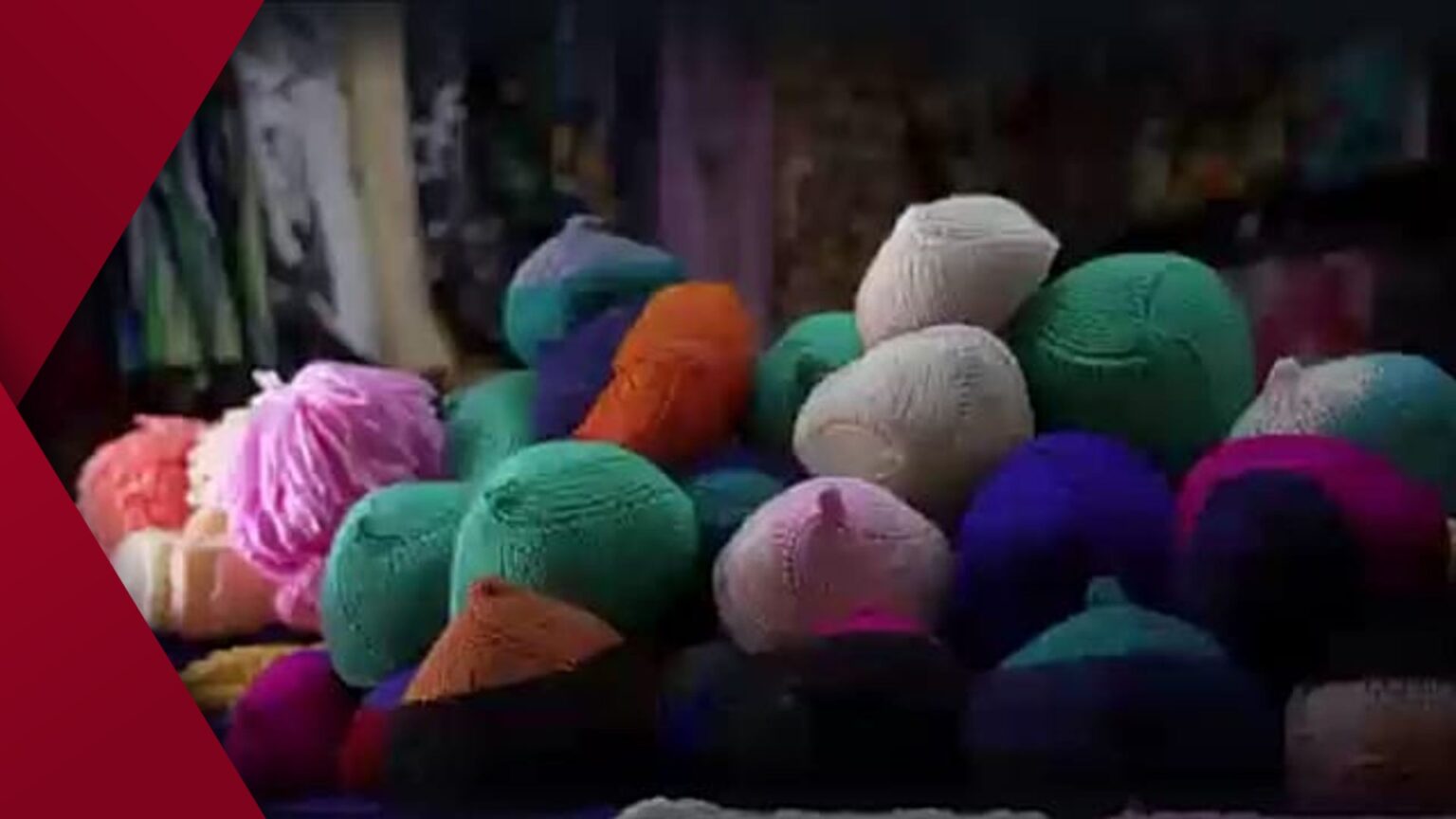 A young woman wearing a black VR headset is immersed in a virtual reality experience under soft pink and blue neon lighting in a dimly lit room.
