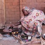 Contemporary glass-paneled office tower reflecting sky and clouds