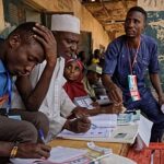 Contemporary glass office building with blue sky reflection