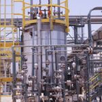 Elegant abstract digital pattern featuring flowing teal and gold lines on a dark background