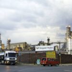 Soft abstract geometric gradient background transitioning from deep purple to teal with subtle layered shapes