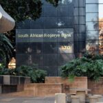 Repeating teal and white angular shapes forming a modern geometric tessellation