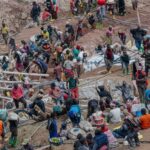Group photo showing heads of state and ministers around a conference table as they pen their signatures on the 2025 Geneva Climate Accord document, blue UN backdrop and flags visible.