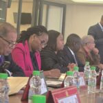 Close-up of a smartphone screen showing the WhatsApp messaging app with active chat list visible