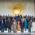 Smartphone screenshot of a lively WhatsApp chat window showing a photo shared on 13 February 2026, with confetti-style stickers and congratulatory messages visible