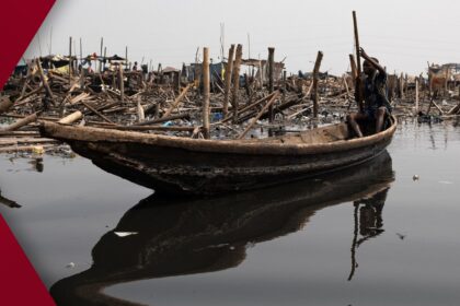 Perfectly calm mountain lake at dawn, reflecting snow-capped peaks and golden sunrise sky