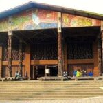 Group of smiling friends on a phone screen during a nighttime video chat