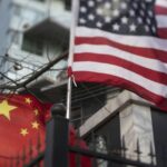 Seamless abstract geometric pattern formed by interlocking blue and white angular shapes over a white background