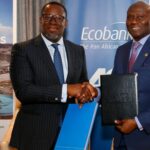 Modern eco-friendly house with solar panels and a lush green roof blending into the surrounding garden