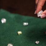 Marbled abstract background with swirling teal turquoise and metallic gold paint strokes