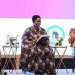 Stone sculpture of Nandi the bull, vehicle of Lord Shiva, lying gracefully in front of a Hindu temple doorway